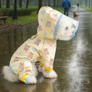 Detail of waterproof dog raincoat with transparent hood visor and bear print