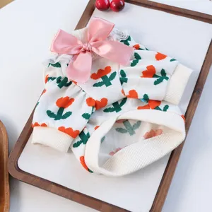 Detail of knit pet sweater with tulip patterns, pink bow, and delicate lace trim