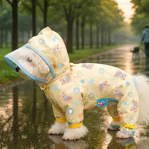Detail of yellow waterproof dog raincoat with cartoon bear patterns and clear brim hood