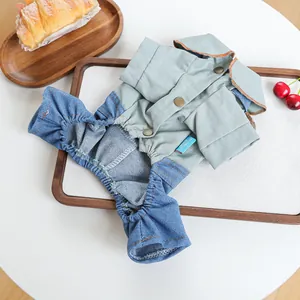 Detail of pet jumpsuit featuring grey twill collar and blue denim pants with metal buttons