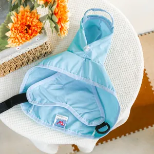 Sky blue waterproof pet raincoat with hood and leash D-ring on white knit background