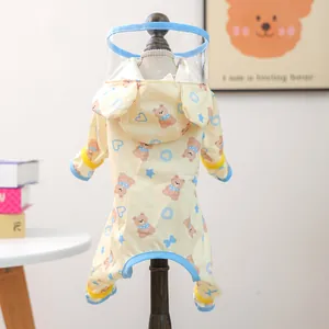 Waterproof pet raincoat with yellow bear print, transparent hood and blue trim details