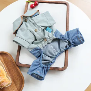 Close-up of pet jumpsuit with green cotton top, denim pants, and retro metal buttons