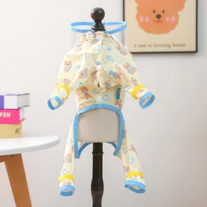 Close-up of dog raincoat with bear prints, transparent PVC hood and snap buttons