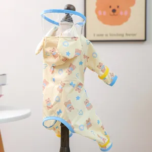Detail of yellow pet raincoat featuring cartoon bears and a clear plastic hood visor