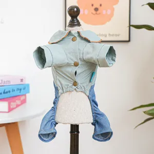 Detail of pet jumpsuit with light green shirt, bronze buttons, and denim pants for dogs