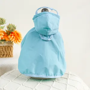 Close-up of waterproof pet raincoat in light blue with transparent visor and hood