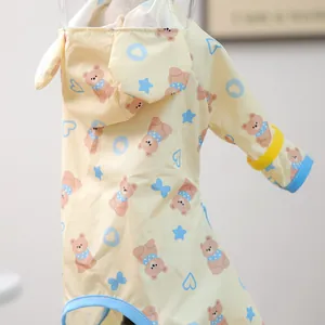Detail of yellow pet raincoat with cartoon bear prints and transparent waterproof hood