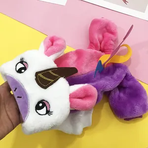 Detail of plush rainbow unicorn pet costume with embroidered eyes and colorful wings