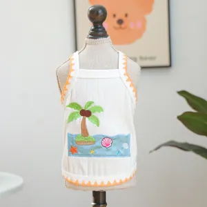 Detail of pet summer tank top featuring palm tree embroidery and orange lace trim