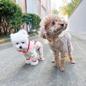 Outdoor detail of a waterproof rainbow print pet raincoat with hooded four-leg design