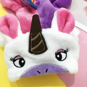 Detailed view of plush unicorn pet costume with embroidered eyes and golden horn detail