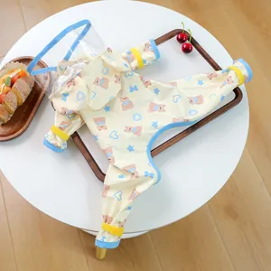 Detail of waterproof pet raincoat featuring yellow bear prints and transparent hood mask