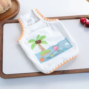 Detail of pet summer vest featuring coconut tree embroidery and orange wavy edges