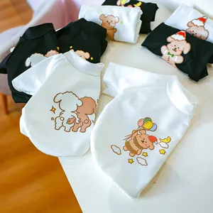 Close-up of breathable cotton pet t-shirts featuring various cute cartoon prints