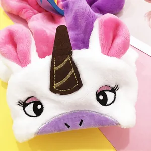 Detail of plush rainbow unicorn pet costume showing soft fur and embroidery