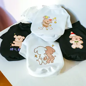 Close-up of soft cotton pet T-shirts featuring cartoon bear and dog prints in black and white