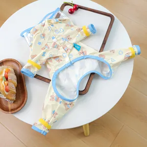 Detail of waterproof puppy raincoat with cartoon bear print and blue trim accents