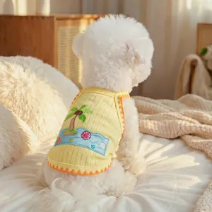 Detail of yellow knit pet vest with tropical palm tree and ocean wave embroidery