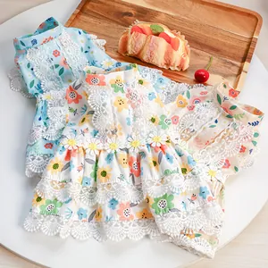 Macro detail of pet princess dresses with floral prints, delicate lace and daisy appliques