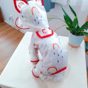Detail of waterproof pet raincoat featuring rainbow prints and a clear hood for dogs