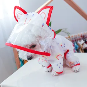 Close-up of pet rainbow raincoat featuring a transparent PVC hood with red cat ears