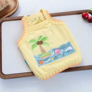 Detailed embroidery of palm trees and sea waves on a yellow striped pet vest