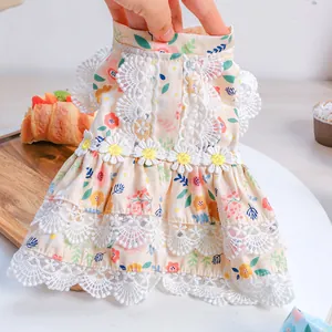 Detailed view of floral pet dress featuring layered lace trim and daisy embroidery
