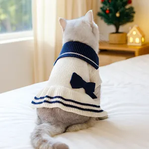 Close-up of navy style knit pet dress with large bow detail and soft ribbed texture