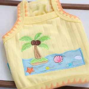 Detail of yellow pet vest showing high-quality coconut tree embroidery and knit fabric