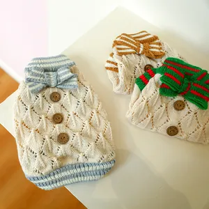 Detail of knit pet sweater featuring hollow texture, wooden buttons and bow tie accents