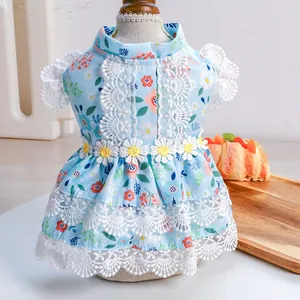 Detail of light blue floral pet dress with delicate white lace edges and daisy appliques