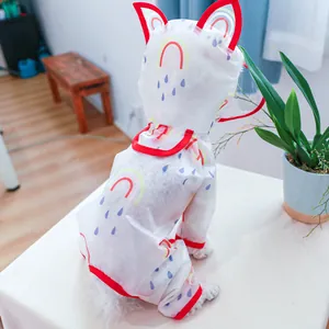 Detail view of a waterproof pet raincoat featuring rainbow prints and a cute cat-ear hood