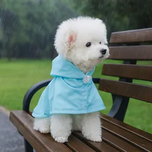 Waterproof sky blue hooded raincoat for small dogs shown on a white Bichon Frise outdoors