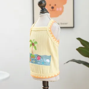 Detail of yellow ribbed pet vest featuring beach themed coconut tree and shell embroidery