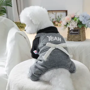 Detail of grey waffle fabric pet jumpsuit with YEAH embroidery and white bow decoration