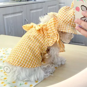 Close-up of yellow plaid pet dress with large bow and matching sun hat for small dogs