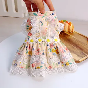 Detailed view of floral pet dress featuring lace trim and daisy appliques in light cotton