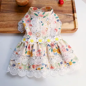 Detail of floral pet dress featuring delicate white lace trim and yellow daisy appliques