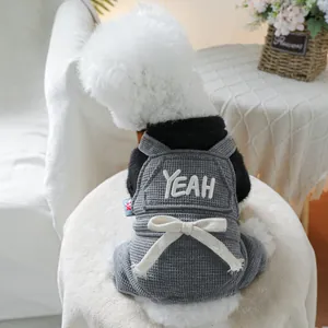 Detail of grey waffle knit pet jumpsuit with YEAH embroidery and waist bow for small dogs