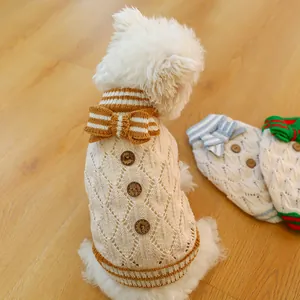 Detail of hollow-knit pet sweater with wooden buttons and bow tie in various colors