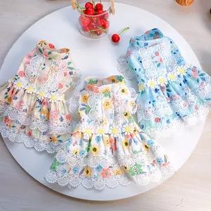 Detailed view of floral pet dresses with lace ruffles and daisy floral appliques