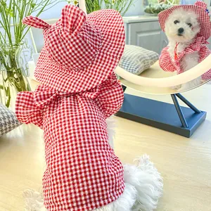 Detail of red and white plaid pet sun hat with cute ears and matching puppy outfit
