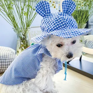 Close-up of blue plaid pet sun hat with small ears and adjustable chin strap