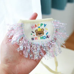 Detail of embroidered teddy bear birthday pet bib with colorful soft tassels