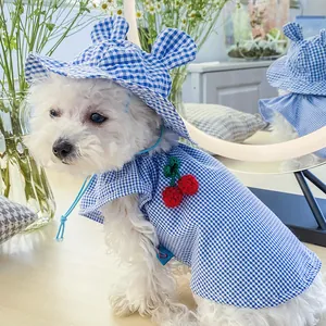 Detailed view of blue gingham pet sun hat with ear holes and cute cherry decoration