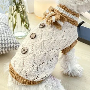 Knitted pet sweater with wooden buttons and bowknot for small dogs in cozy home setting