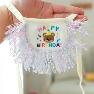 Detailed view of plush birthday pet bandana with rainbow embroidery and colorful tassels