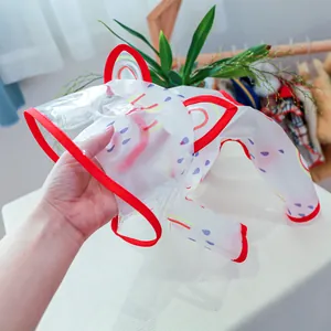 Close-up of translucent white pet raincoat featuring purple raindrops and red trims