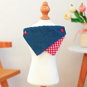 Close-up of reversible denim and red checkered pet bandana with decorative buttons